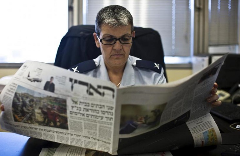 Sima Vaknin-Gill, Israel chief military censor, reads a local Israeli newspaper in her office in Tel Aviv July 30, 2015. REUTERS/Nir Elias