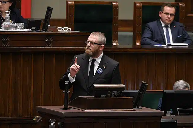Grzegorz Braun speaking at a political event in Poland.