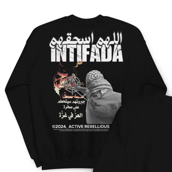 Black sweatshirt featuring the word “Intifada” in bold, Arabic script reading “O Allah, crush them,” an armed figure aiming at a target, and Arabic text referencing Gaza.