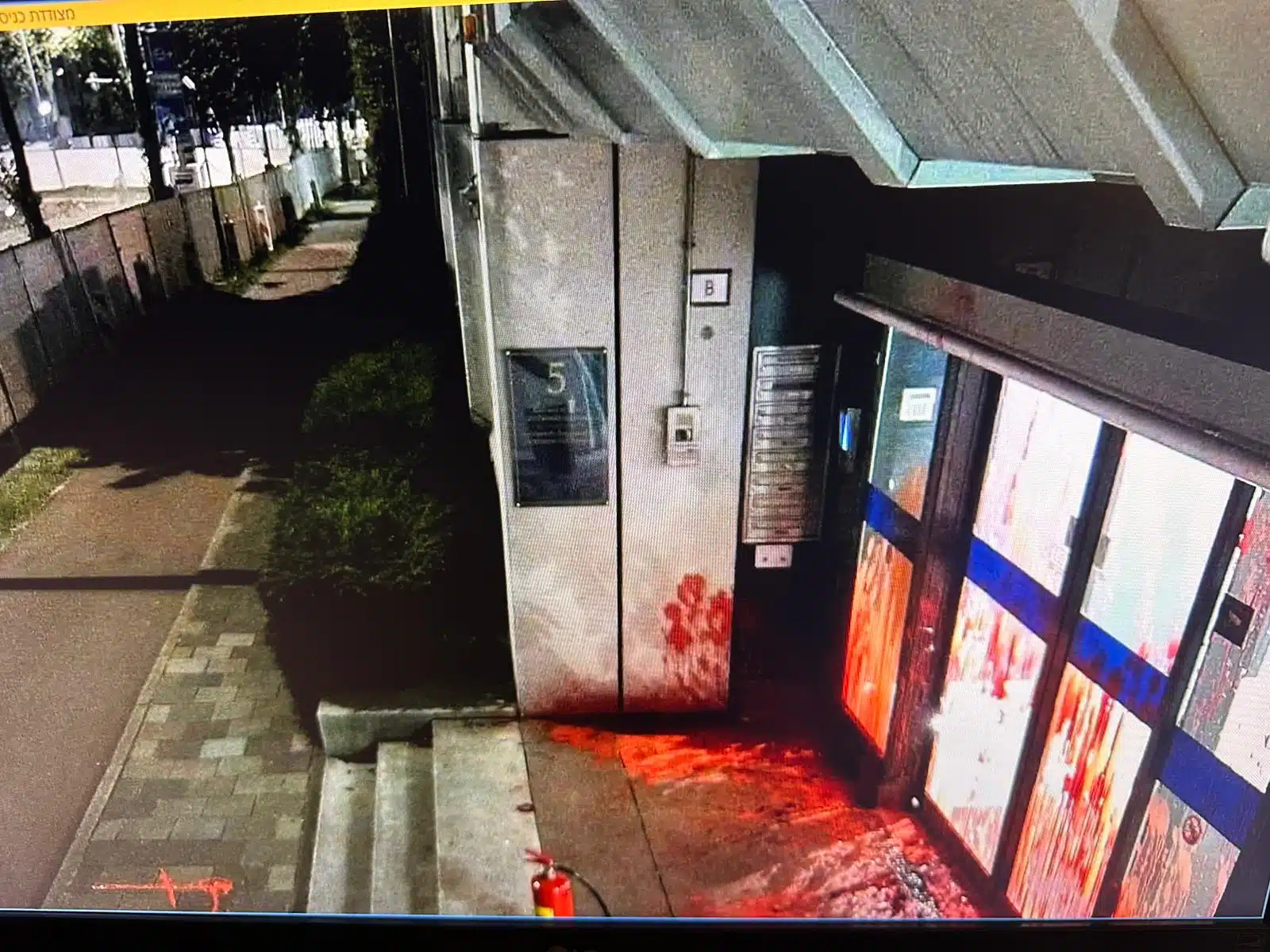 Red paint smeared on glass doors and wall at Israel’s Embassy in The Hague after a predawn vandalism attack.