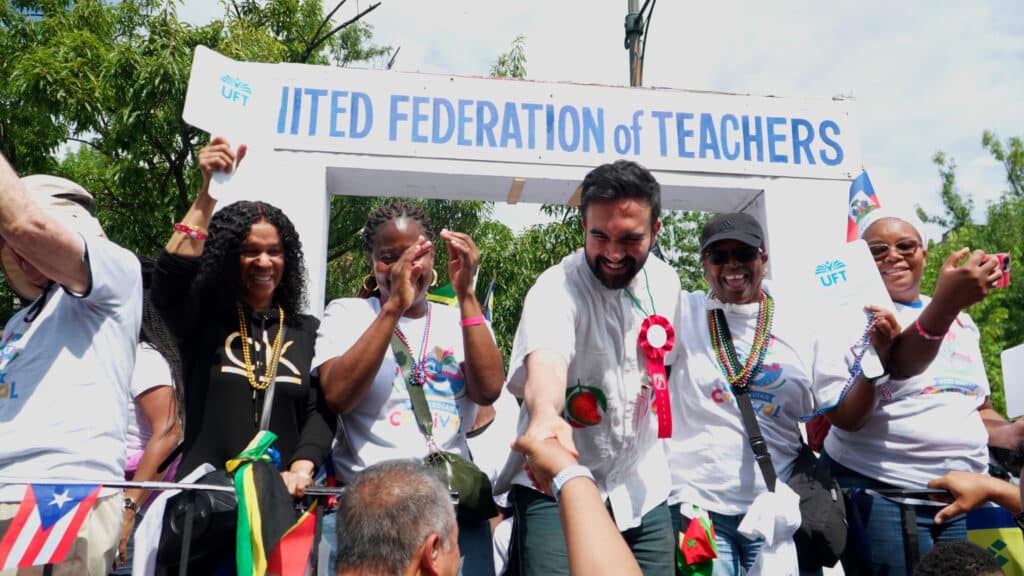 Democratic mayoral candidate Zohran Mamdani stands with United Federation of Teachers members at a public event in New York City