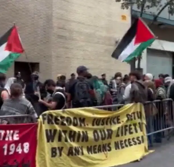 Protesters wave Palestinian flags and stand behind a banner reading “Freedom. Justice. Return. Within Our Lifetime. By Any Means Necessary” during an anti-Israel demonstration outside the United Nations.