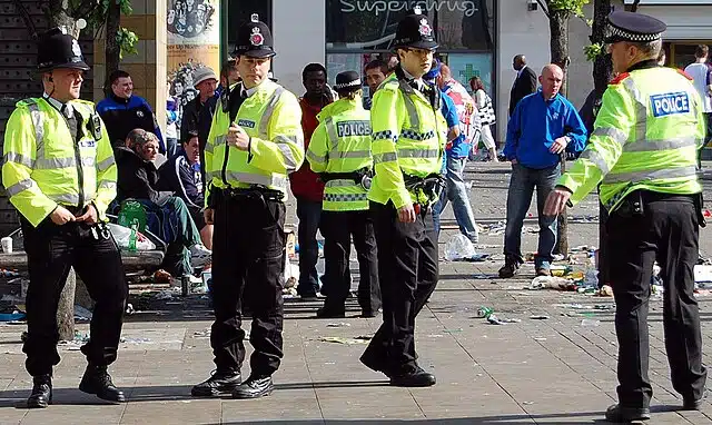 Greater Manchester Police officers stand alert in Manchester
