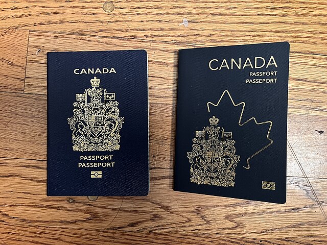 Two Canadian passports placed on a wooden surface