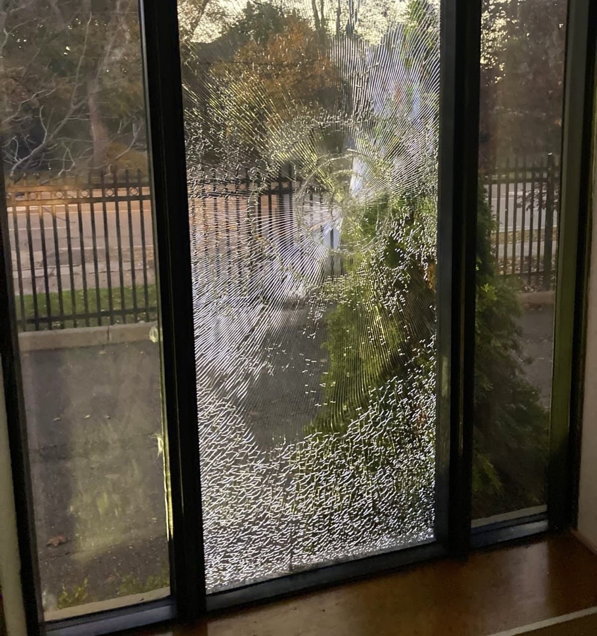 Alt Text: Shattered window of Toronto’s Kehilat Shaarei Torah synagogue after vandals struck, leaving a web of cracks across the glass.