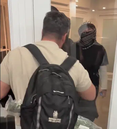 A masked anti-Israel protester confronts a man blocking the door of a Toronto venue during an SSI event with IDF veterans.