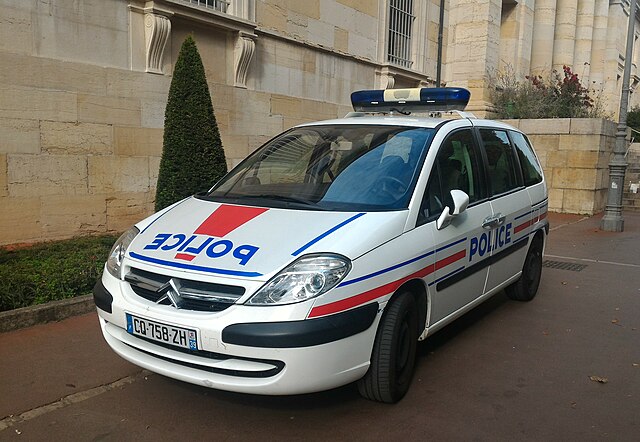 French police vehicle parked outside a building