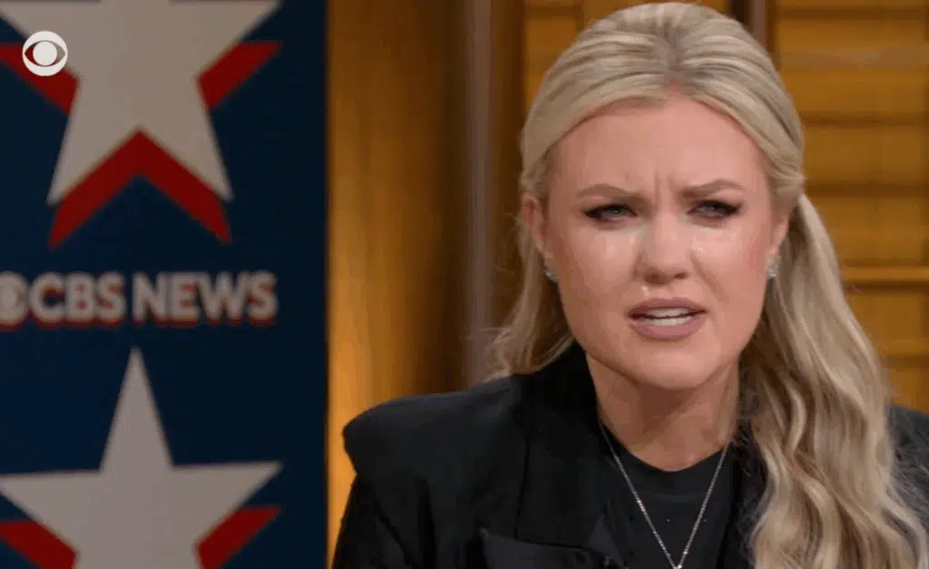 Erika Kirk becomes emotional during a CBS News town hall, with the CBS News logo visible in the background.