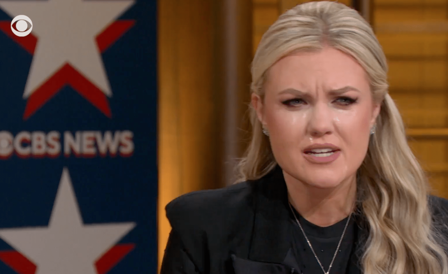 Erika Kirk becomes emotional during a CBS News town hall, with the CBS News logo visible in the background.