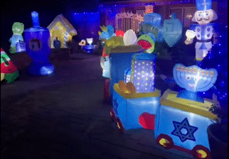 Inflatable Hanukkah decorations, including a menorah and Star of David, displayed outside a Jewish home in Redlands, California, that was targeted in a suspected antisemitic drive-by shooting.