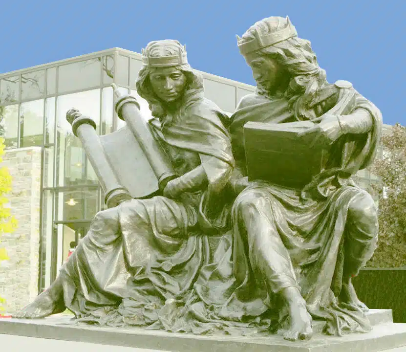 Contemporary sculpture depicting Synagoga and Ecclesia seated together, holding religious texts, symbolizing post–Vatican II Christian–Jewish dialogue.
