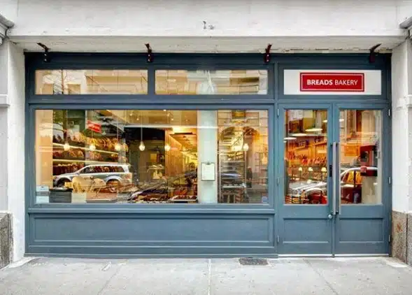 Exterior view of a Breads Bakery storefront in New York City, an Israeli-founded bakery targeted by employee demands to sever ties with Israel.