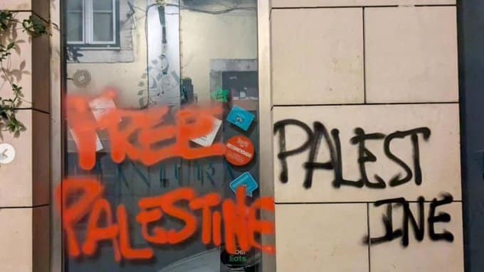 Graffiti reading “Free Palestine” sprayed across the front window of Tantura, an Israeli-owned restaurant in Lisbon.