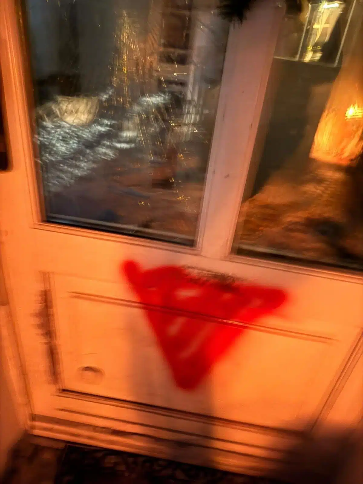 Red inverted triangle associated with Hamas propaganda spray-painted on a door near the home of Brandenburg’s antisemitism commissioner following a suspected arson attack.