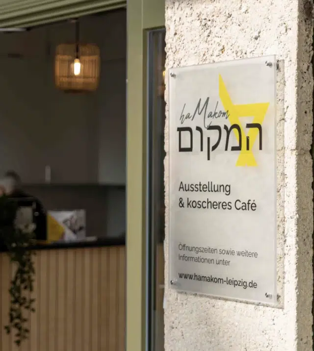 Sign at the entrance of HaMakom Exhibition and Kosher Café in Leipzig, a Jewish café targeted in a recent antisemitic attack.