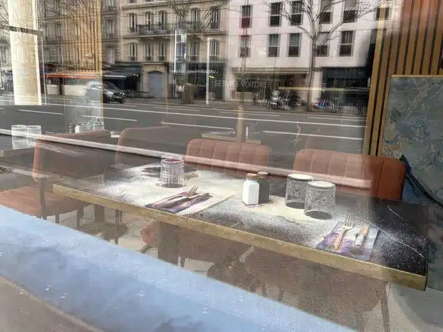 White corrosive residue covers tables and place settings inside a kosher restaurant in central Paris following an overnight acid attack.