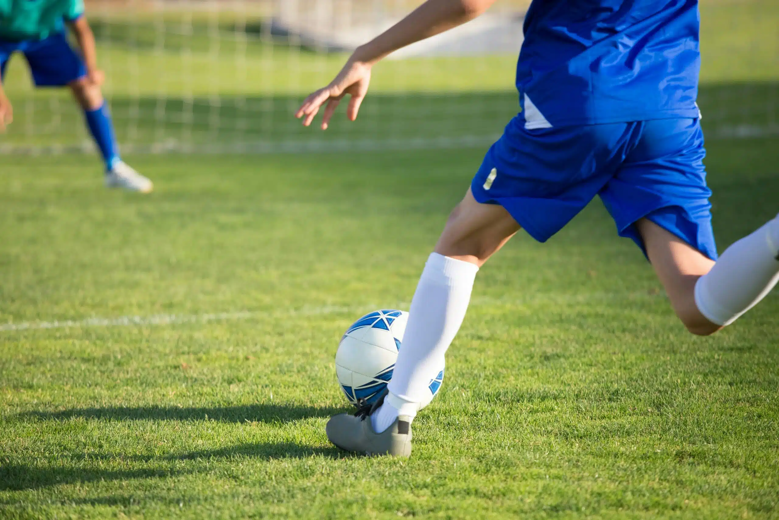 Youth soccer players compete on a field during a school football match.