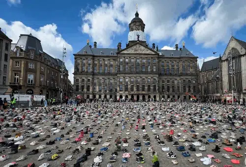Thousands of shoes laid out across Dam Square in Amsterdam in a Gaza display that uses Holocaust memorial imagery tied to victims of the Nazi genocide