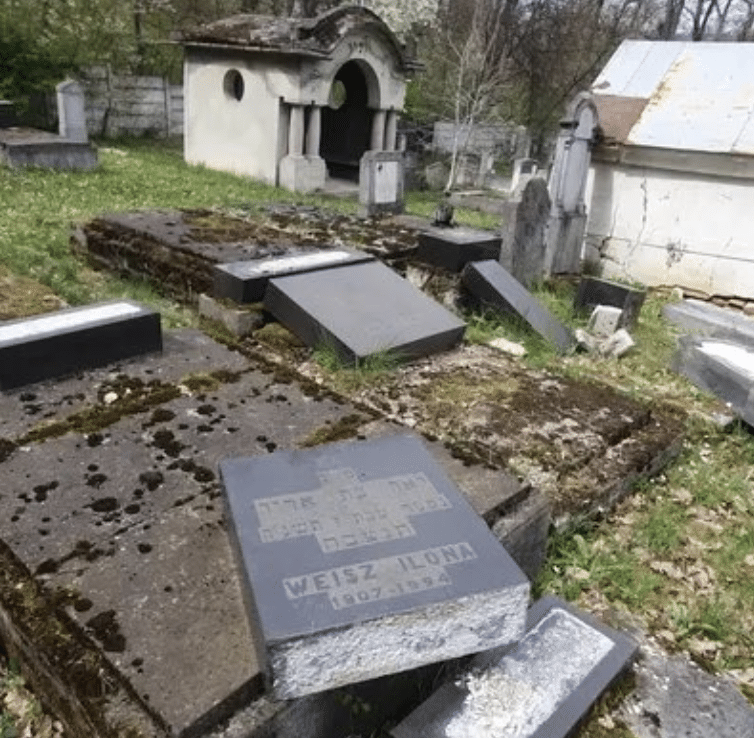 Toppled gravestones in a Jewish cemetery in Reghin, Romania