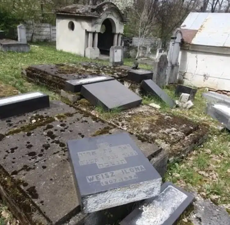 Toppled gravestones in a Jewish cemetery in Reghin, Romania