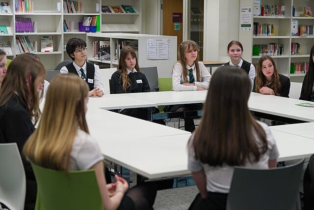 Group of students seated in a classroom discussion at a UK school, reflecting the educational environment where antisemitism incidents have been reported