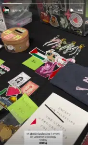 Table display at an SJP-linked campus event showing stickers featuring Leila Khaled and other pro-Palestinian imagery prepared for distribution