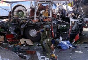 Aftermath of a Second Intifada suicide bombing in Israel, showing a destroyed public bus after a Palestinian terrorist attack that targeted Israeli civilians — violence invoked by the “Globalize the Intifada” slogan.