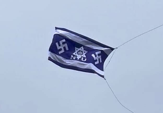 A fake Israeli flag bearing NYU's logo inside a Star of David with a Nazi swastika on each side, flying over Washington Square Park.