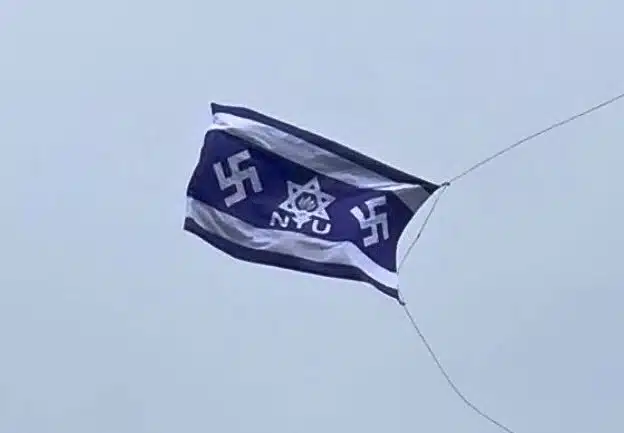 A fake Israeli flag bearing NYU's logo inside a Star of David with a Nazi swastika on each side, flying over Washington Square Park.