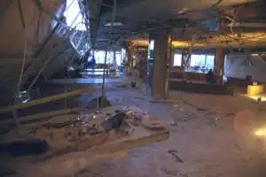 Interior of the Park Hotel in Netanya after the 2002 Passover massacre suicide bombing during the Second Intifada, showing severe structural destruction and debris throughout the dining hall.