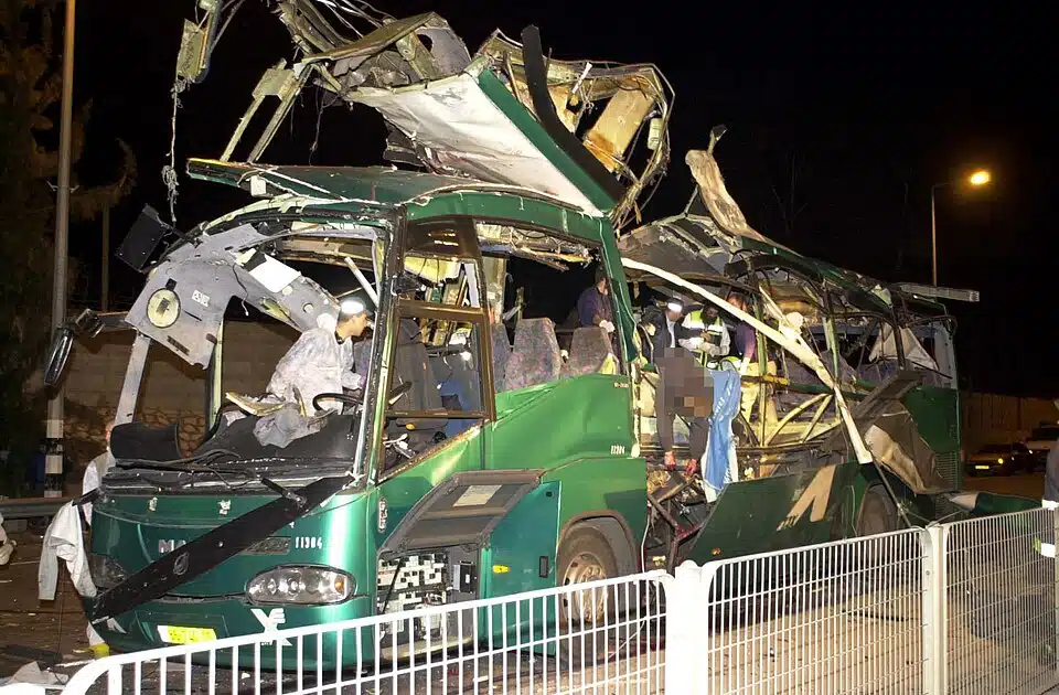 Destroyed Israeli bus following a suicide bombing during the Second Intifada, showing severe structural damage after a mass-casualty terror attack targeting civilians.