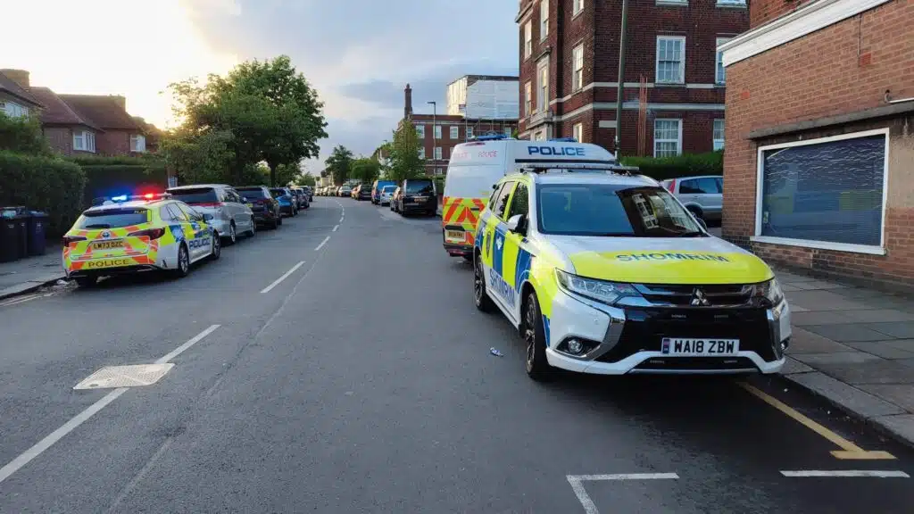 Shomrim and Metropolitan Police vehicles on Bridge Lane, Golders Green, following a suspected arson attack on a predominantly Jewish residential building.