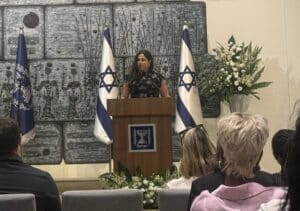 Hadas Bar-Erez speaks at the podium during the Nashim VeShorashim ("Women and Roots") book launch at the President's Residence in Jerusalem.