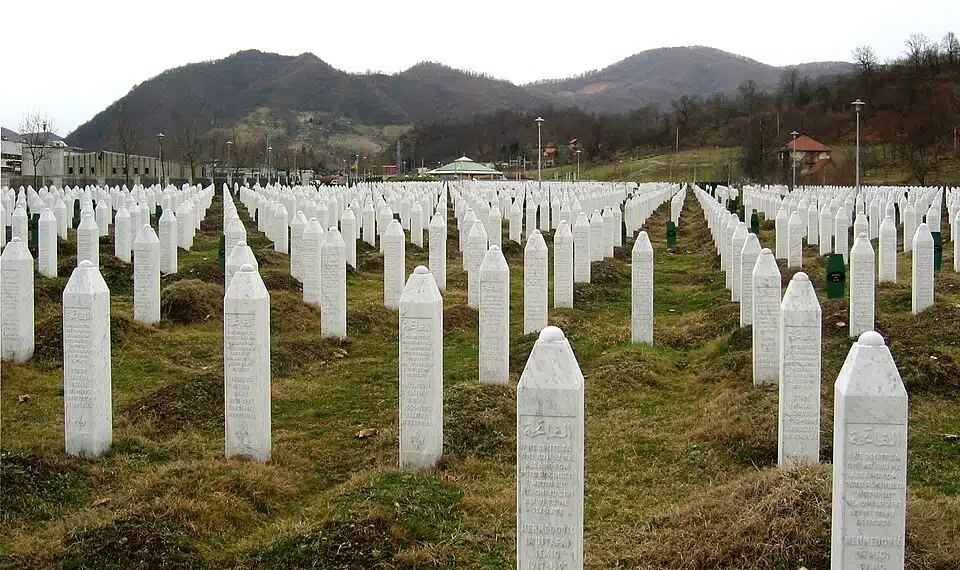 Rows of white gravestones at the Srebrenica-Potočari Memorial Center in Bosnia and Herzegovina, commemorating victims of the 1995 Srebrenica genocide.