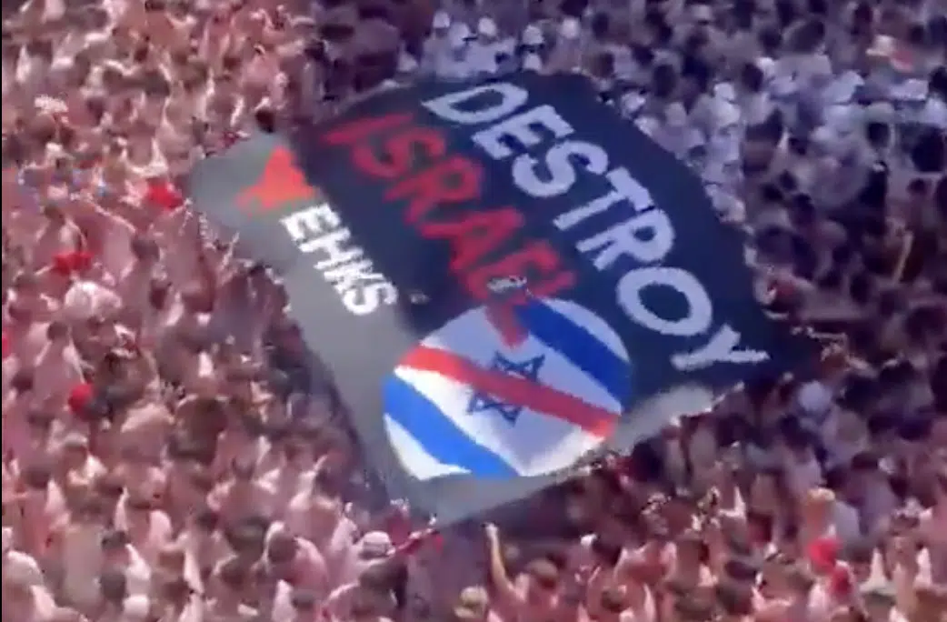 A giant "Destroy Israel" banner is carried above the crowd during the opening of the 2026 San Fermín festival in Pamplona, Spain.