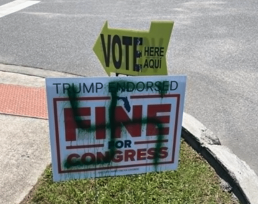 Randy Fine campaign sign spray-painted with a green swastika near an early voting site.
