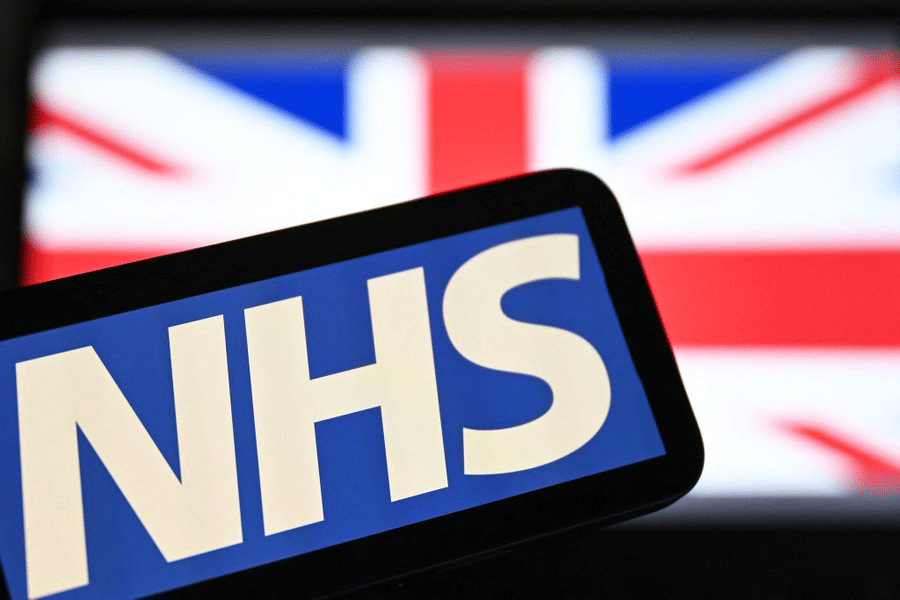 NHS logo with a British flag in the background.