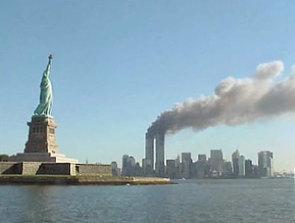 The Statue of Liberty stands before the Manhattan skyline as smoke rises from the World Trade Center during the September 11 attacks.