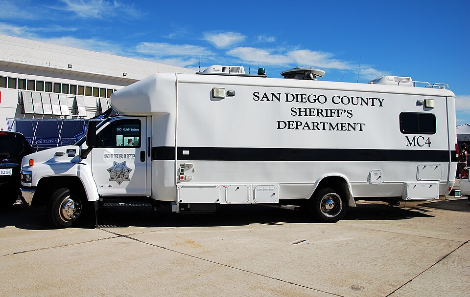 A white San Diego County Sheriff’s Department mobile command vehicle parked outdoors.