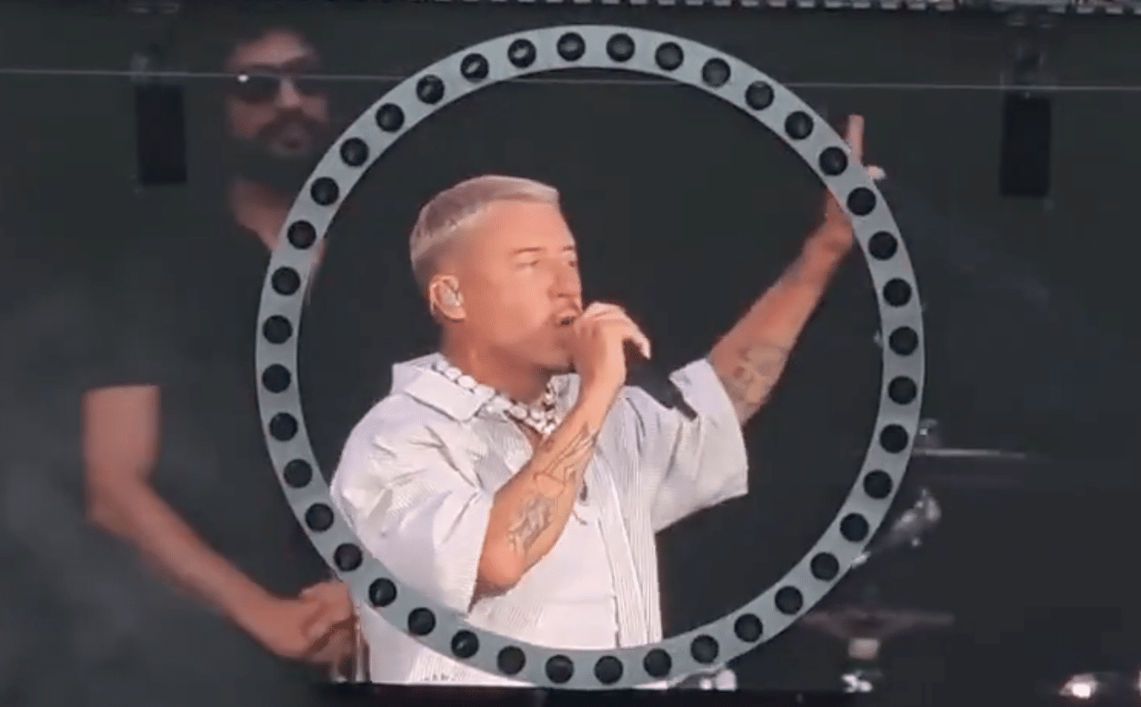 Macklemore performs with a microphone during an opening set for Ed Sheeran at MetLife Stadium.