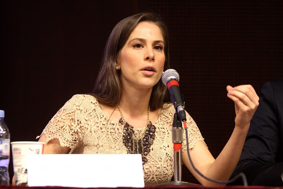 Ana Kasparian speaks into a microphone at a panel discussion