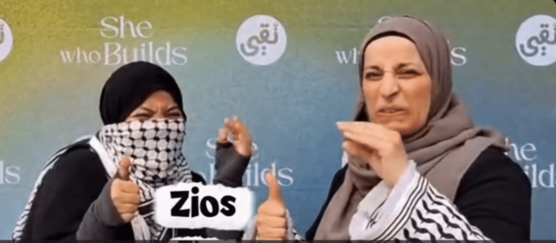 Two women demonstrate hand gestures in a video still displaying the word “Zios.”