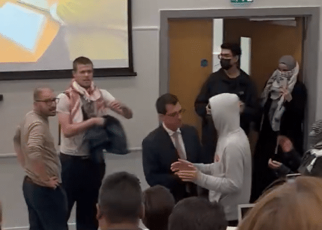 Masked protesters confront attendees during a disrupted lecture on Hamas hostages at City St George’s, University of London.